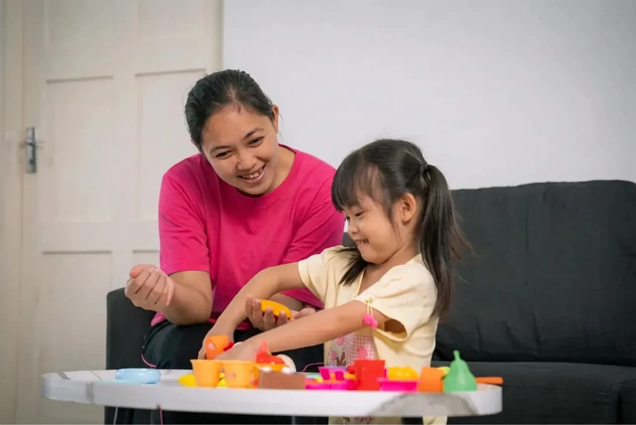 Domestic helper playing with child